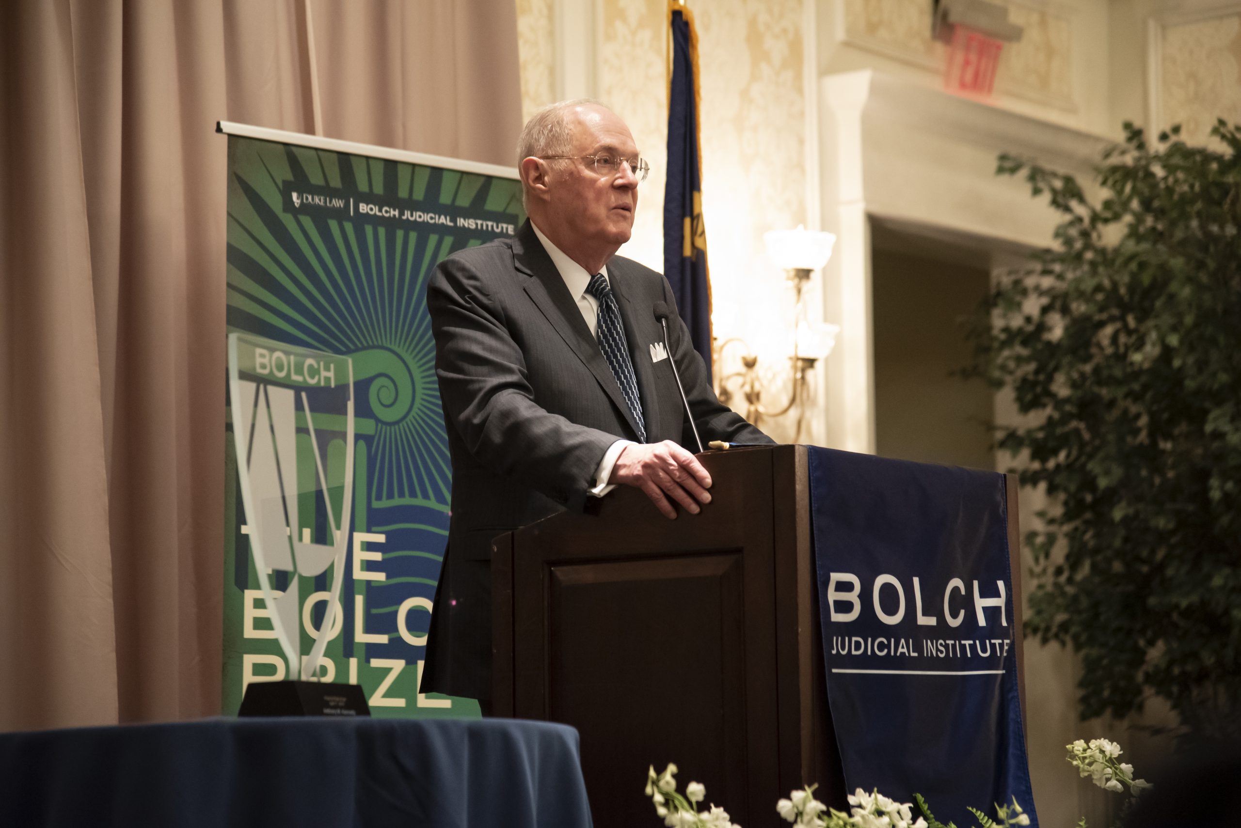 Justice Anthony Kennedy receiving the Bolch Prize, pictured at podium with glass prize beside him